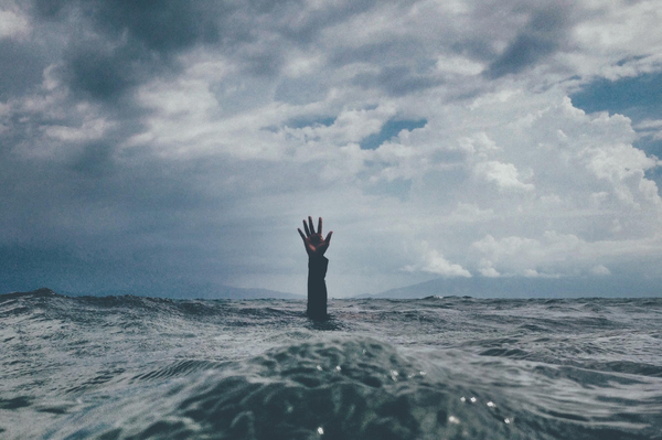 Hand sticking out of ocean